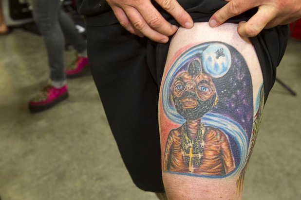 David Wright shows off his tattoo, a blend of "Mr. T" and "E.T.," during the  during the inaugural Art N Ink Festival at the South Point Sunday, June 30, 2013.