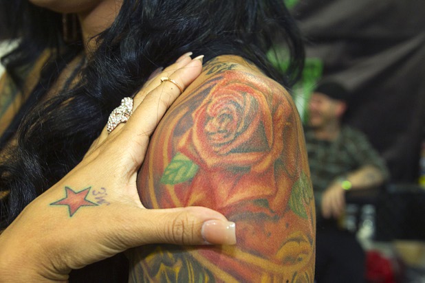 Model Morgan Rene displays one of her tattoos during the inaugural Art N Ink Festival at the South Point Sunday, June 30, 2013.
