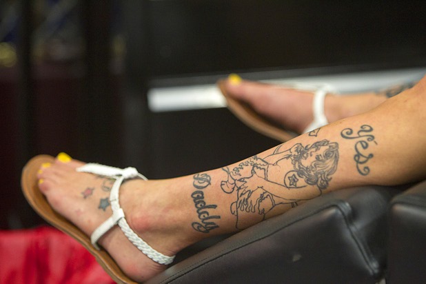 A tattoo adorns a woman's leg during the inaugural Art N Ink Festival at the South Point Sunday, June 30, 2013.