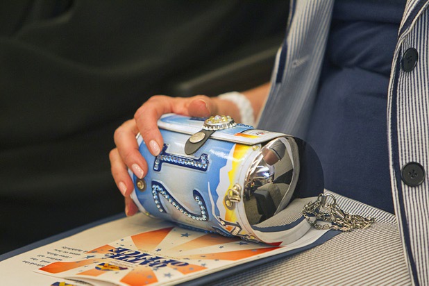 Congresswoman Shelley Berkley (D-NV) holds a handbag made from a recycled Nevada license plate during an oath of office ceremony at North Las Vegas City Hall Monday, July 1, 2013. Berkley swore in Councilwoman Anita Wood for a second term.