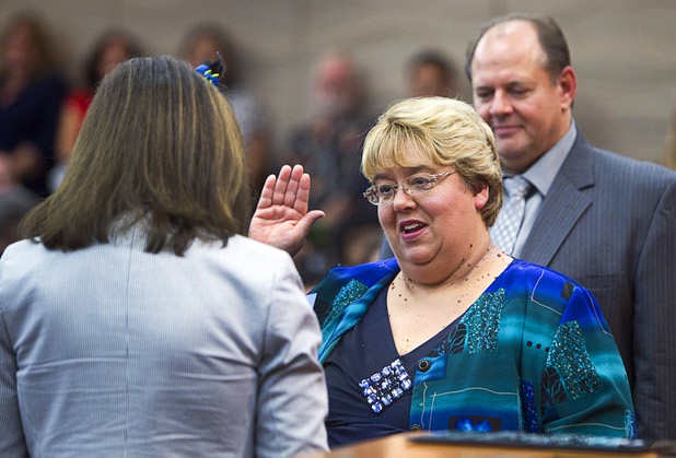 City Councilwoman Anita Wood is sworn in by Congresswoman Shelley Berkley (D-NV) during an oath of office ceremony at North Las Vegas City Hall Monday, July 1, 2013. Her husband Douglas Wood looks on at right.