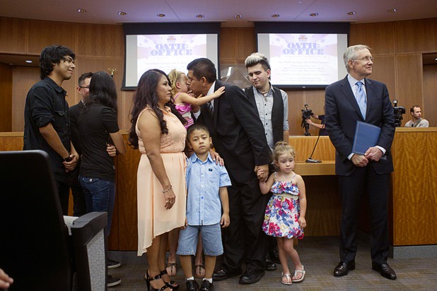 Councilman Issac Barron, center, gives a kiss to a grandchild as he assembles family members during an oath of office ceremony at North Las Vegas City Hall Monday, July 1, 2013. Senate Majority Leader Harry Reid (D-NV) waits at right. Barron is the first Hispanic to serve on the North Las Vegas City Council.