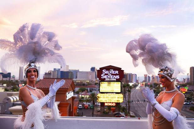 Showgirls pose during a press event as the neon sign at Silver Sevens Hotel & Casino is ceremonially lit in Las Vegas on Monday, July 1, 2013. Silver Sevens Hotel & Casino was formerly known as Terrible's Hotel and Casino.