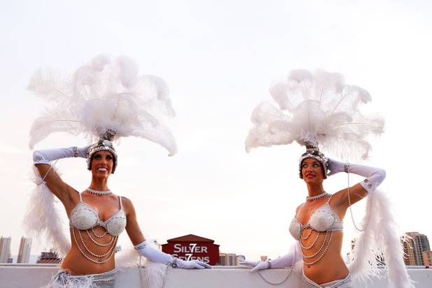 Showgirls pose during a press event as the neon sign at Silver Sevens Hotel & Casino is ceremonially lit in Las Vegas on Monday, July 1, 2013. Silver Sevens Hotel & Casino was formerly known as Terrible's Hotel and Casino.