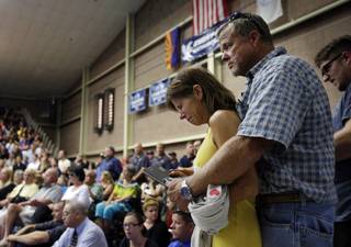 Marsha McKee and Stanley Nesheim react during a memorial service for 19 firefighters of the Granite Mountain Hotshot Crew, Monday, July 1, 2013, in Prescott, Ariz. McKee is the mother of one of the Hotshots who were killed by an out-of-control blaze near Yarnell, Ariz. on Sunday.