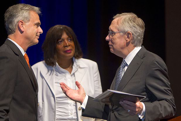Senate Majority Leader Harry Reid, right, (D-NV) speaks with Chuck Bowling, Mandalay Bay Resort president and COO, as Rose McKinney-James, chairwoman of the Clean Energy Project, looks on during a news conference at the Mandalay Bay Convention Center Tuesday, July 2, 2013. MGM Resorts International and NRG Energy announced a partnership to install one of the largest contiguous roof-top solar photovoltaic arrays in the world on the roof of the convention center.