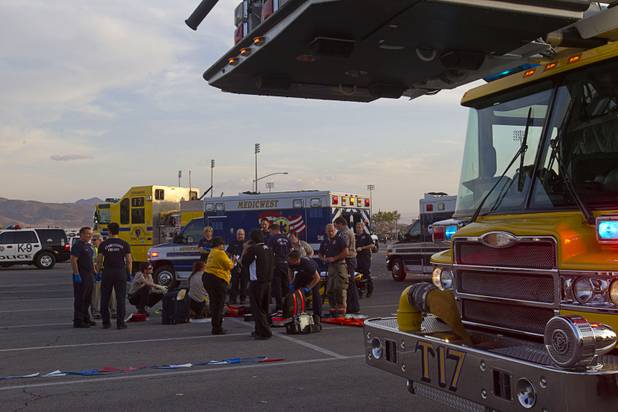 Emergency medical technicians work on an injured fan after a fight between fans of Chivas Guadalajara and Club America before El Super Clasico soccer game at Sam Boyd Stadium, Wednesday, July 3, 2013. Witnesses said 150-200 people were involved in the altercation.