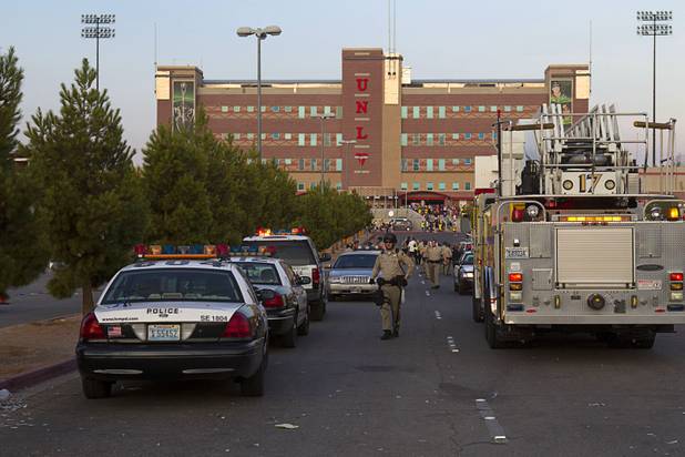 Police cars and fire engine are shown after a fight between fans of Chivas Guadalajara and Club America before El Super Clasico soccer game at Sam Boyd Stadium, Wednesday, July 3, 2013. Witnesses said 150-200 people were involved in the altercation.