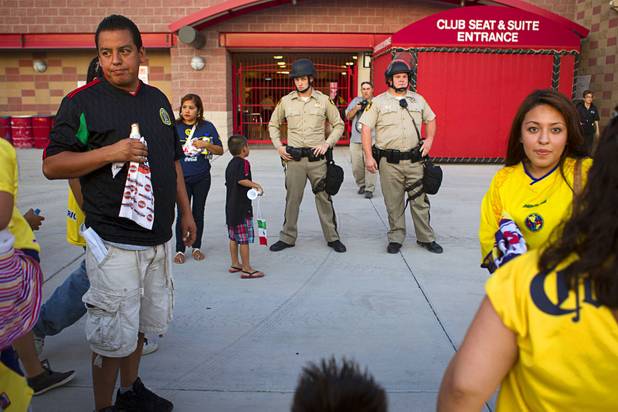 Metro police office keep a eye on fans after a fight between fans of Chivas Guadalajara and Club America before El Super Clasico soccer game at Sam Boyd Stadium, Wednesday, July 3, 2013. Witnesses said 150-200 people were involved in the altercation.