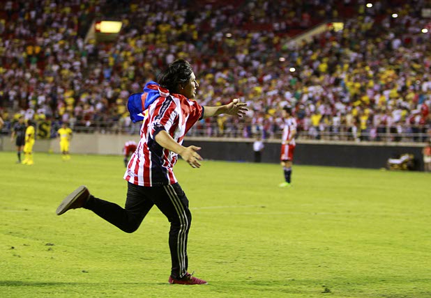 A fan runs onto the field during El Super Clasico soccer game at Sam Boyd Stadium Wednesday July 3, 2013.