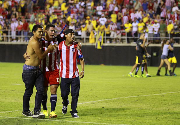 Fan embrace Abraham Coronado of Chivas Guadalajara at the end of El Super Clasico soccer game at Sam Boyd Stadium Wednesday July 3, 2013.