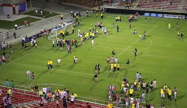 Fan are shown on the field after the El Super Clasico soccer game at Sam Boyd Stadium Wednesday July 3, 2013.