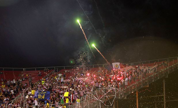 Fans of Chivas Guadalajara shoot fireworks from the stands during El Super Clasico soccer game at Sam Boyd Stadium Wednesday July 3, 2013.