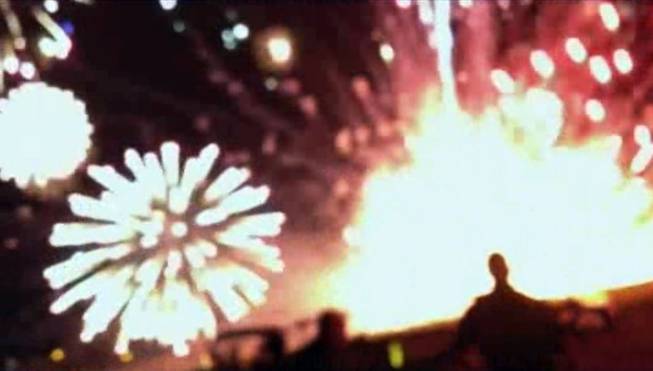 In this frame grab from video provided by Zach Reister, authenticated by checking against known locations and events, and consistent with Associated Press reporting, fireworks explode in the air and on the ground during a fireworks show in Simi Valley, Calif., Thursday, July 4, 2013. More than two dozen people were injured when a wood platform holding live fireworks tipped over, sending the pyrotechnics into the crowd at the Fourth of July show, authorities said Friday.