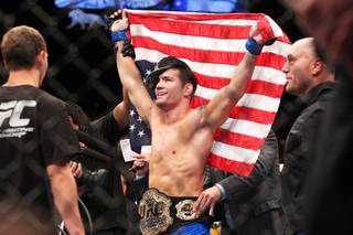 Chris Weidman celebrates his victory over Anderson Silva after their middleweight title fight at UFC 162 Saturday, July 6, 2013 at the MGM Grand Garden Arena. Weidman upset Silva with a second round knockout, taking the belt Silva has held since 2006.