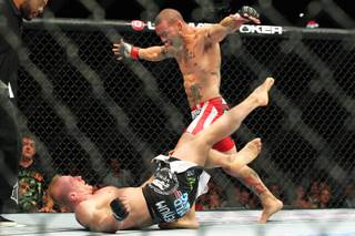 Cub Swanson taunts Dennis Siver into getting up before knocking him out during their fight at UFC 162 Saturday, July 6, 2013 at the MGM Grand Garden Arena.