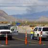 A Nevada Department of Transportation worker speaks to a driver at a roadblock on Kyle Canyon Road at U.S. 95 in July 2013.