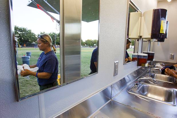 Firefighter Kris Sterbens from the Angeles National Forest cleans up before dinner in Pahrump Sunday, July 7, 2013. The crew had been working the fire in Trout Canyon.