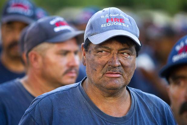 Firefighter Pedro Meza of Sequoia National Forest lines up for dinner in Pahrump after fighting the Carpenter 1 wildfire Sunday, July 7, 2013.