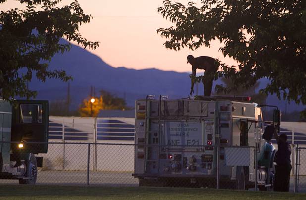 A firefighter unloads gear from a truck before making camp in Pahrump after fighting the Carpenter 1 wildfire Sunday, July 7, 2013.