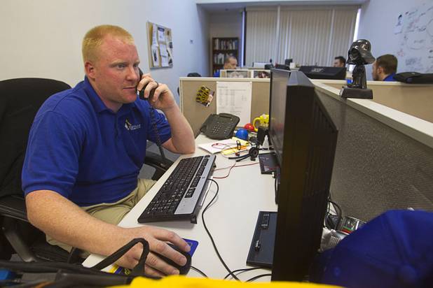Matthew Powell, a managed services technician, gives troubleshoots a IT problem for a client at Stimulus Technologies in Henderson Monday, July 8, 2013.