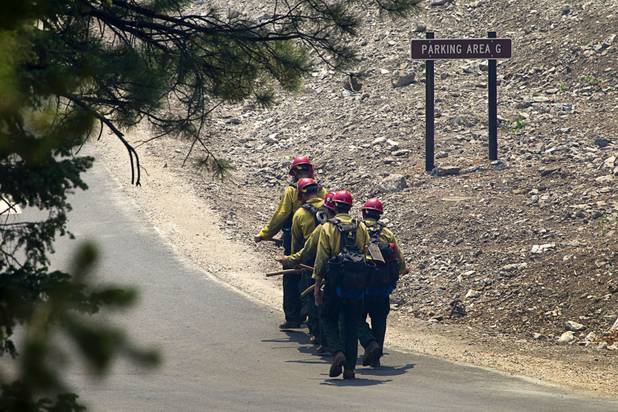A fire crew heads out from the Cathedral Rock picnic area on Mount Charleston Tuesday, July 9, 2013.