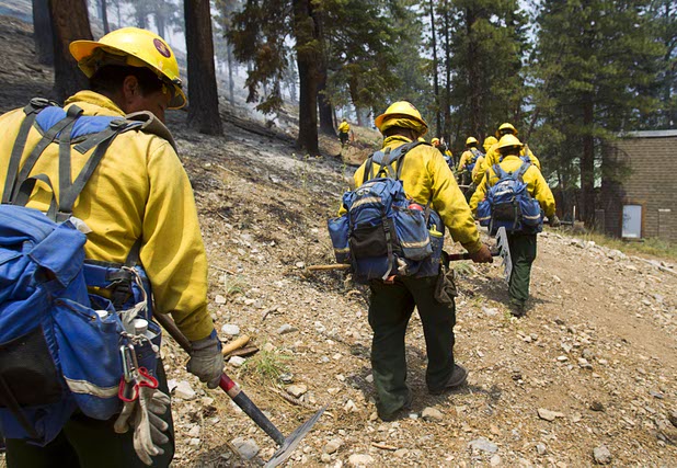 A fire crew heads out after a burnout in the Rainbow subdivision on Mount Charleston Tuesday, July 9, 2013.