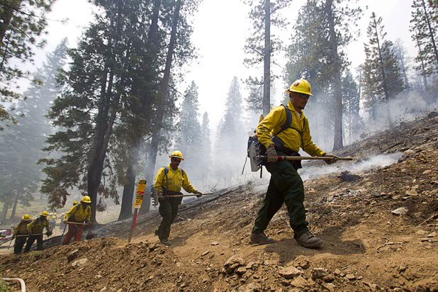 A fire crew heads out after a burnout in the Rainbow subdivision on Mount Charleston Tuesday, July 9, 2013.