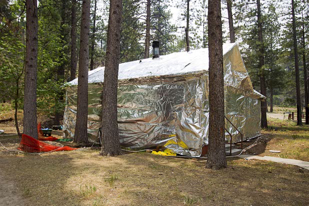 A U.S. Forest Service building is shown wrapped in a protective covering during a media tour on Mount Charleston Tuesday, July 9, 2013.