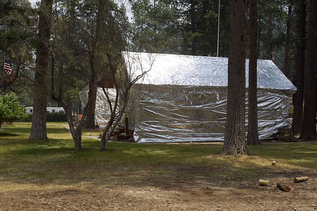 U.S. Forest Service buildings are wrapped in a protective covering during a media tour on Mount Charleston Tuesday, July 9, 2013.