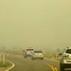 A Metro Police pickup truck leads a media convey through wildfire smoke on Kyle Canyon Road after a tour of fire activities on Mount Charleston Tuesday, July 9, 2013.