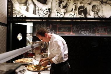 Owner and executive chef Shawn McClain puts fresh basil on the blanca pizza at FIVE50 Pizza Bar on Tuesday, July 9, 2013 inside Aria at CityCenter in Las Vegas.