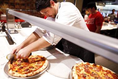 Executive chef Richard Camarota cuts a pizza at FIVE50 Pizza Bar on Tuesday, July 9, 2013 inside Aria at CityCenter in Las Vegas.