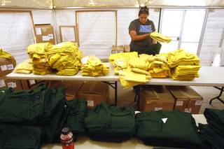 Holly Thomas looks for a particular size of firefighting clothing at a clothing exchange for firefighters working the Mt. Charleston fire Wednesday, July 10, 2013 at Centennial High School.