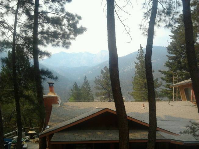 A view of Mount Charleston from behind the home of Rodney Giles, who chose not to evacuate his residence despite a nearby wildfire, Tuesday, July 9, 2013. 