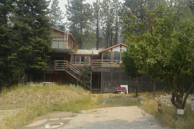 A view of the Mount Charleston home of Rodney Giles, who chose not to evacuate his residence despite a nearby wildfire, Tuesday, July 9, 2013. 
