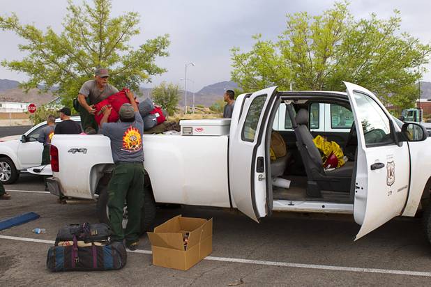 Firefighters prepare to leave Centennial High School and fight the Mount Charleston wildfire Thursday, July 11, 2013.