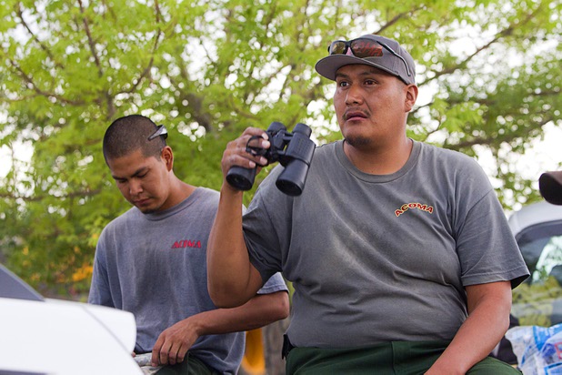 Firefighter Felix Poncho, based in Grants, N.M., uses binoculars to watch lightning strikes at Centennial High School before leaving to fight the Mount Charleston wildfire Thursday, July 11, 2013.