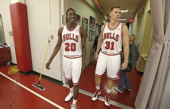 Chicago Bulls draft picks Tony Snell, left, and Erik Murphy enter the practice facility at the Berto Center Monday, July 1, 2013, in Deerfield, Ill., after changing into their new uniforms for the first time.