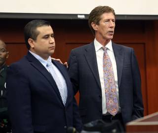 George Zimmerman, left, stands with defense counsel Mark O'Mara during closing arguments in his trial at the Seminole County Criminal Justice Center, in Sanford, Fla., July 12, 2013.