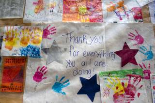Thank you posters are displayed on an information board at Centennial High School Sunday, July 14, 2013.
