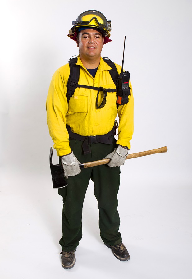 Firefighter/paramedic Charlie Bowman of Dayton, Nev. displays his brush fire gear at Centennial High School Sunday, July 14, 2013.