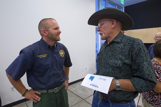 Brandon Hampton, a fire information officer, listens to Royce "Woody" Wood, a lower Kyle Canyon resident, during a public meeting at the Red Rock Canyon Visitor Center Sunday, July 14, 2013.