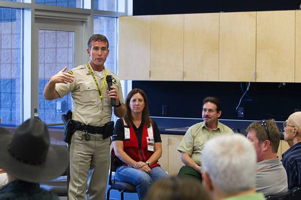 Metro Police Captain Patrick Neville speaks during a public meeting at the Red Rock Canyon Visitor Center Sunday, July 14, 2013. Neville announced that Kyle Canyon residents will be allowed to return to their homes on Wednesday.