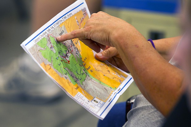 Women look over a fire map during a public meeting at the Red Rock Canyon Visitor Center Sunday, July 14, 2013.