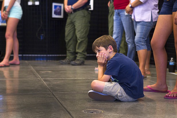 A boy attends a public meeting with his family at the Red Rock Canyon Visitor Center Sunday, July 14, 2013.