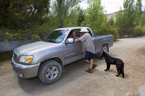 Rick Martin, left, speaks to resident Greg Jameson after inspecting the community's water line in Trout Canyon Monday, July 15, 2013. Martin said the pipeline was broken in about 50 places. Residents were allowed to return to their homes Sunday.