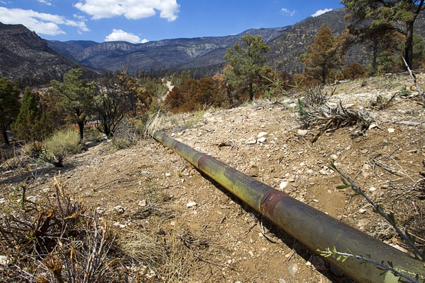 The Trout Canyon water pipeline is shown in Trout Canyon Monday, July 15, 2013. Residents were allowed to return to their homes Sunday but they have no water due to breaks in the pipeline.