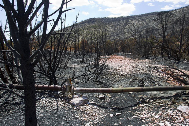 The Trout Canyon water pipeline is shown in Trout Canyon Monday, July 15, 2013. Residents were allowed to return to their homes Sunday but they have no water due to breaks in the pipeline.