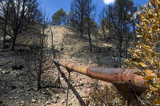 The Trout Canyon water pipeline is shown in Trout Canyon Monday, July 15, 2013. Residents were allowed to return to their homes Sunday but they have no water due to breaks in the pipeline.
